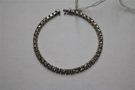 An 18ct white gold and diamond line bracelet, set with forty four round cut stones, with a total diamond weight of approximately